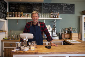 Portrait Of Owner Standing In Coffee Shop